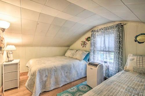a bedroom with two beds and a window at Lakeside Kent Home with Pier and Boat Ramp Access in Waterport
