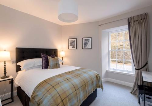 a bedroom with a large bed and a window at Luxury apartment, Stafford Street in Edinburgh