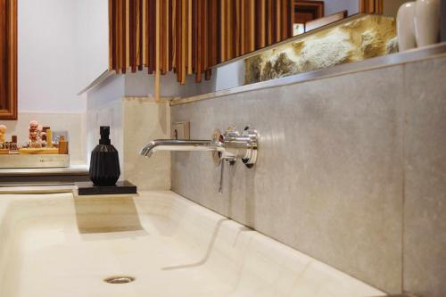 a bathroom with a sink in a room at KelDomènech Apartment Bed Art in Besalú