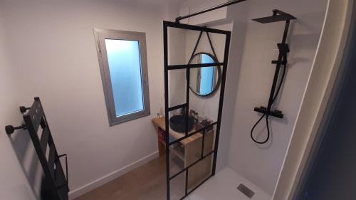 a hallway with a mirror and a mirror shelf at L'appartement de jeanne in Quimper