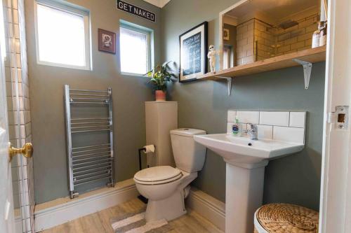 a bathroom with a toilet and a sink at Church House Loft in Scarborough