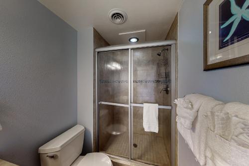 a bathroom with a shower and a toilet at Sand & Sea: Paradise on the Prom (516) in Seaside