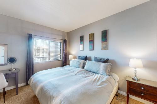 a bedroom with a large bed and a window at Sand & Sea: Paradise on the Prom (516) in Seaside
