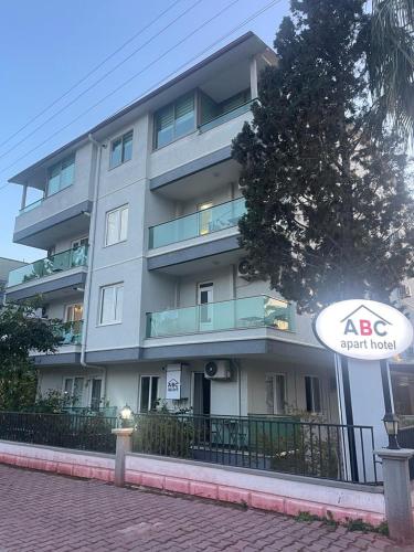 a apartment building with a sign in front of it at ABC Apart Hotel in Antalya