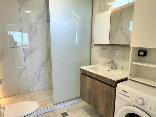 a bathroom with a shower and a toilet and a sink at Yamina Rooftop Residence in Agia Pelagia
