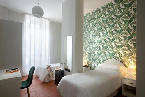 a bedroom with a white bed and a green wall at Palazzo Sant'Antonio in Naples
