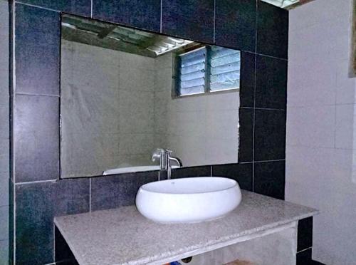 a bathroom with a white sink and a mirror at ISLA tress Bonita Wellness Escape Island in San Vicente