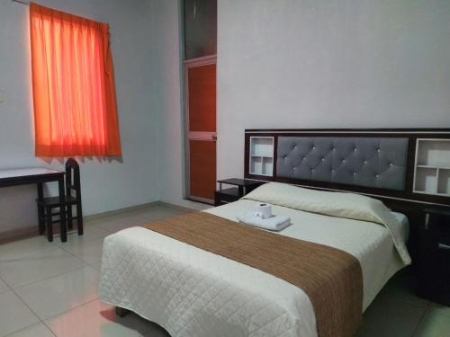 a bedroom with a large bed and a desk at HOSTAL espinoza in Arequipa