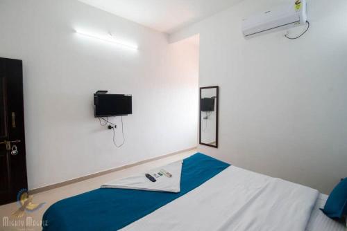 Habitación con cama y TV. en WHITE SEASONS RESORT AND SPA DEVBAG en Chaoka
