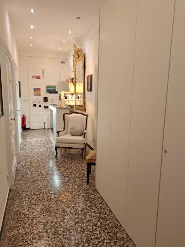 a hallway with a chair and a mirror at DORA AUREA in Levanto