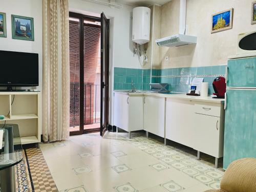 a kitchen with a sink and a tv in a room at LA CASA MIRADOR DE ÉCIJA in Écija
