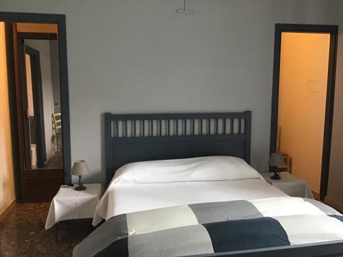 a bedroom with a large bed and a mirror at casa Marilena in Tivoli