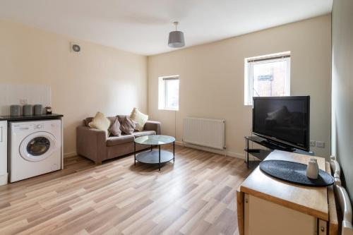 a living room with a tv and a couch at Yarm Lane Apartments - Stockton Town Centre in Stockton-on-Tees