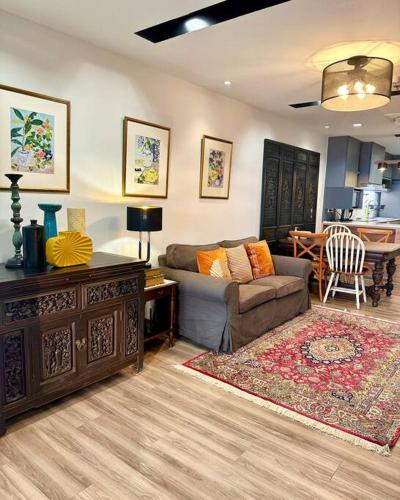 a living room with a couch and a table at Central Bangkok, 5 stars river view & characteristic decor in Bangkok