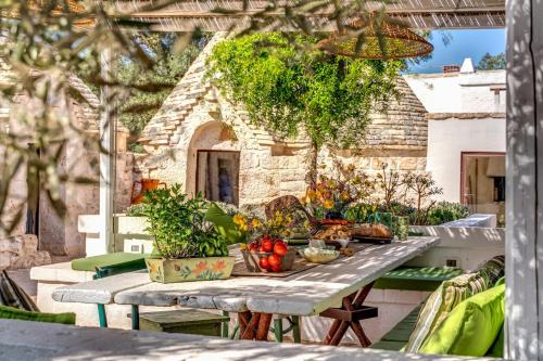 a table with fruits and vegetables on a patio at Trulli cicale e olive in Ceglie Messapica