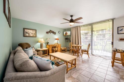 a living room with a couch and a table at Kona Makai 3102 in Kailua-Kona