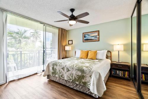 a bedroom with a bed and a ceiling fan at Kona Makai 3102 in Kailua-Kona