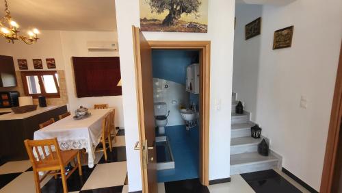 Cette chambre dispose d'une table et d'une porte avec une salle de bains. dans l'établissement Mani Tower, à Kamáres