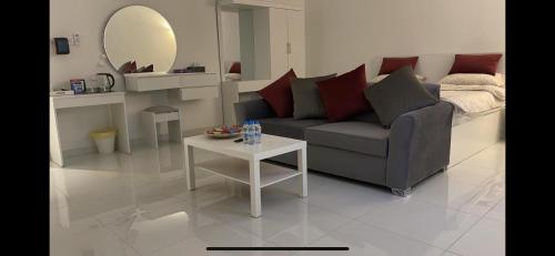 a living room with a couch and a table at MED Luxury Suites and Apparts in Al Madinah