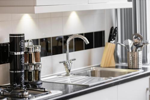 a kitchen counter top with a sink and a sink at Central Located Apartment in City of London - Farringdon Station in London