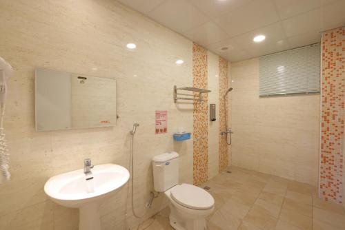 a bathroom with a toilet and a sink at Bears Line B&B train station in Hualien City
