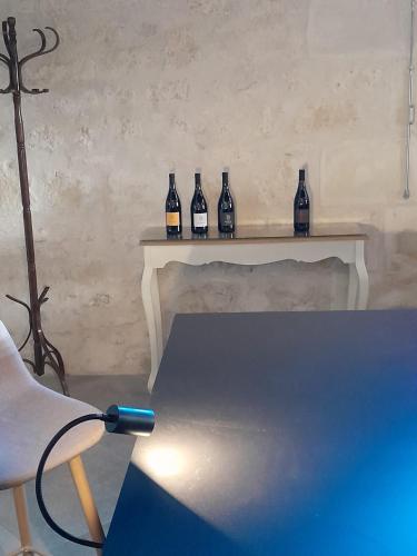 a table with five bottles on top of it at Le Repaire de Bacchus in Saint-Nicolas-de-Bourgueil