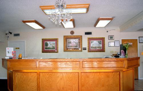 a large wooden counter top in a room at Red Carpet Inn - Natchez in Natchez