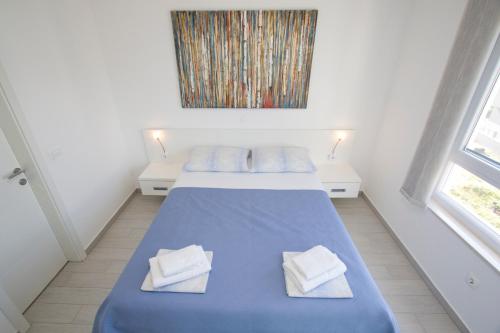 - une chambre avec 2 lits et un tableau mural dans l'établissement Luxury Apartment Marko, à Promajna