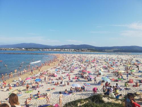 a large crowd of people on a beach at FOZ II PLAYAS in Foz