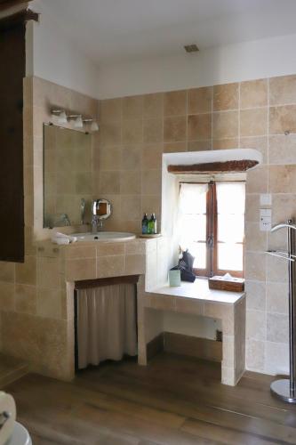 a bathroom with a sink and a window at LA FERME DE LA HUPPE in Gordes