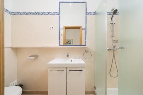 un bagno con lavandino e specchio di Casa Maya - Vale do Garrão a Quinta do Lago
