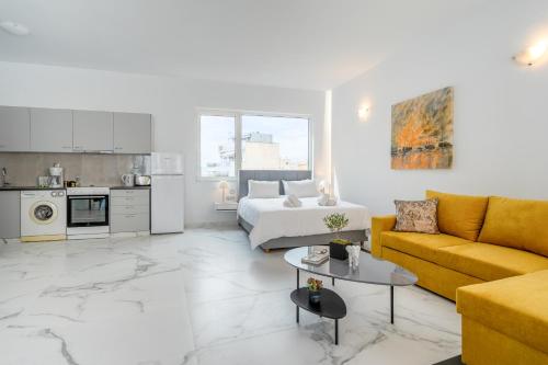 a white living room with a bed and a couch at Olvar's Modern Luminous Suite , Athens Downtown in Athens