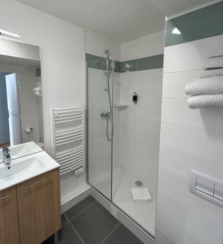 a bathroom with a shower and a sink at Residhome Quai d’Ivry in Ivry-sur-Seine
