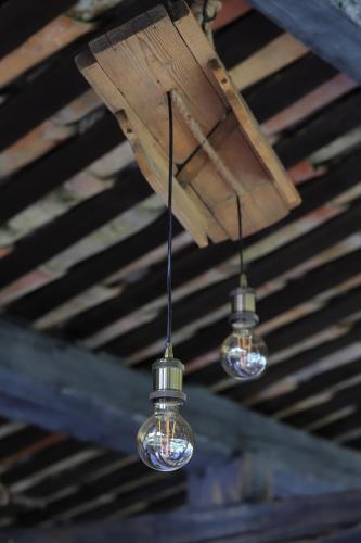 three lights hanging from the ceiling of a building at LA FERME DE LA HUPPE in Gordes