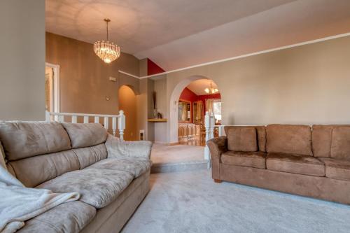 a living room with a couch and a chandelier at Fairmont Hot Springs, 3 Bedroom Vacation Home in Fairmont Hot Springs