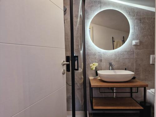 a bathroom with a sink and a mirror at Olivea Luxury Suites in Fažana