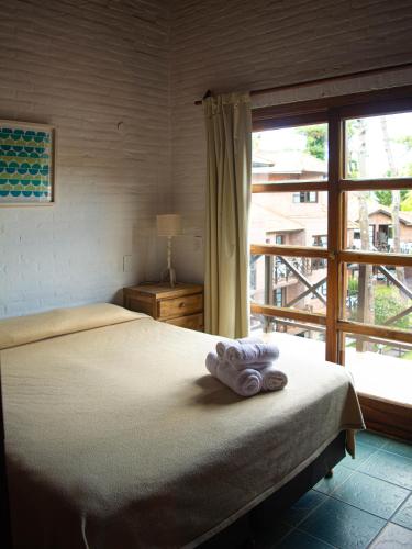 Cariló Paradise Apart Hotel & Spaにあるベッド