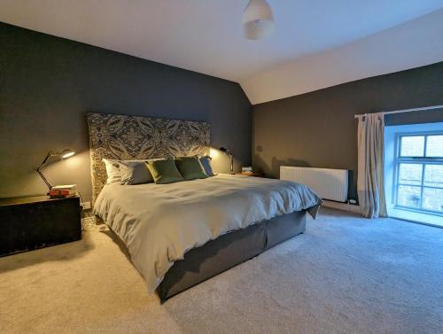 a bedroom with a large bed and a window at The Stables at Lorum Old Rectory in Bagenalstown