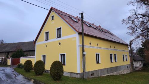 a yellow house with a red roof at Penzion-Dubno in Dubno