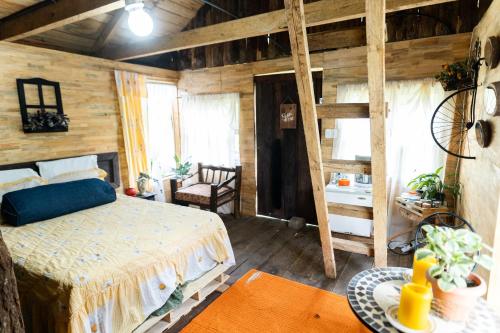 a bedroom with a bed in a room with wooden walls at Cabaña Don Santiago in San Cristóbal Verapaz