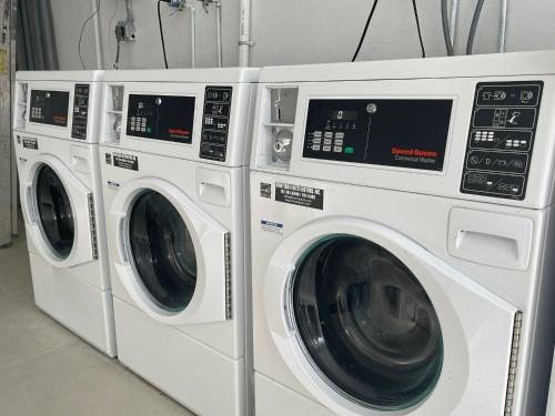 two white washing machines sitting next to each other at Luxurious Beachside 3-Br Apt in San Juan