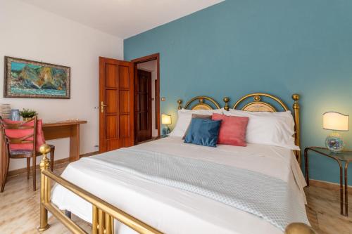 a bedroom with a large white bed with colorful pillows at Scariceddu in Riposto