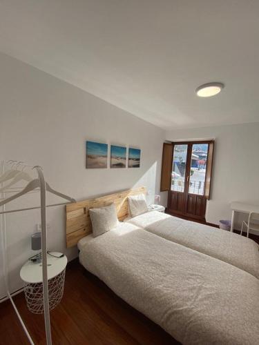 a bedroom with two beds and a lamp in it at Aramotz Etxea in Ugarana