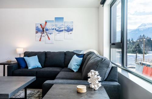 a living room with a couch and a table at Alpine Dream by Revelstoke Vacations in Revelstoke