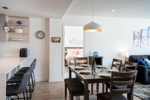 a dining room and living room with a table and chairs at Alpine Dream by Revelstoke Vacations in Revelstoke