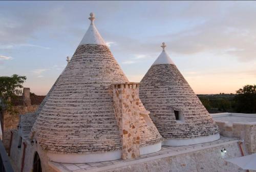 two large towers on top of a building at TRULLI ALLEGRETTI in Noci