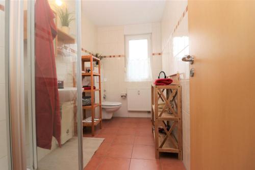 a bathroom with a toilet and a sink at "Strandkoje" Strandkoje, App 07 in Neuhaus