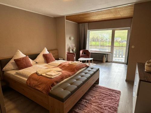 a bedroom with a large bed and a large window at Hotel Gonzlay in Traben-Trarbach