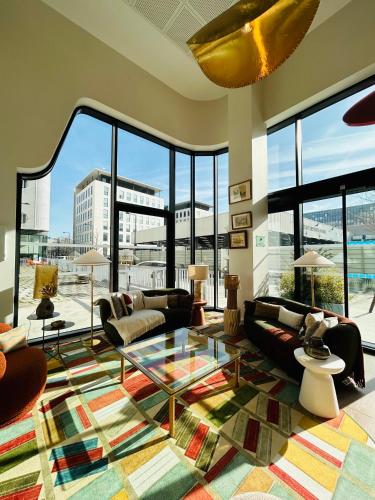a living room with couches and a glass table at Residhome Quai d’Ivry in Ivry-sur-Seine