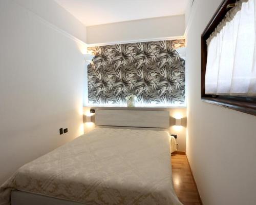 a small bedroom with a bed and a window at 79 Family House in San Giuseppe Vesuviano
